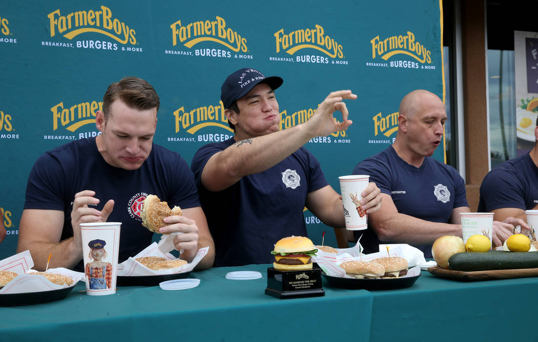 Clark County firefighter Shane Salmon, from left, competes with Las Vegas firefighters Toby Bro ...