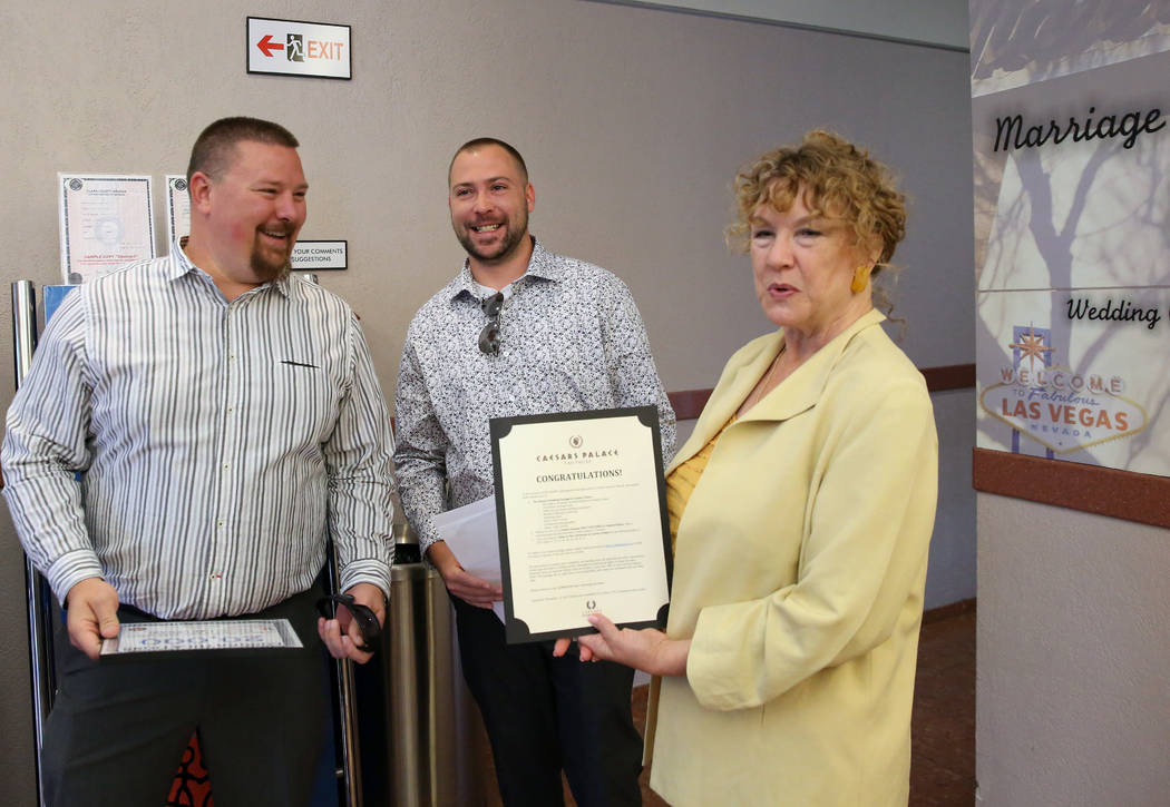 County Clerk Lynn Goya, right, congratulates James Johnson, left, and his partner Matthew Tippl ...