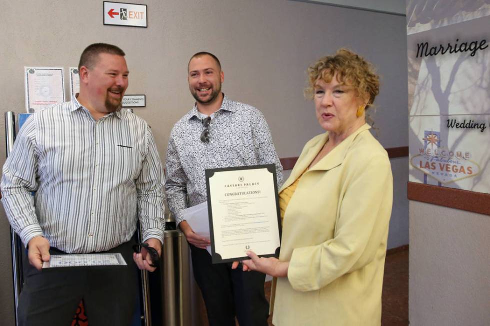 County Clerk Lynn Goya, right, congratulates James Johnson, left, and his partner Matthew Tippl ...