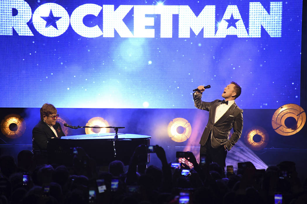 Singer Elton John, left, and actor Taron Egerton perform at the party for the film 'Rocketman' ...