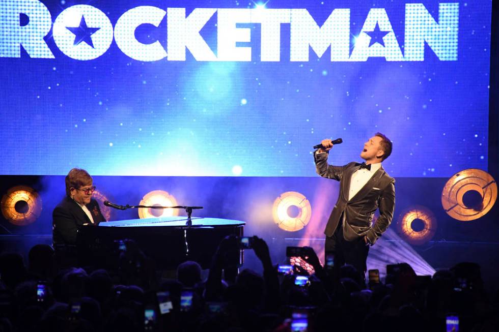 Singer Elton John, left, and actor Taron Egerton perform at the party for the film 'Rocketman' ...