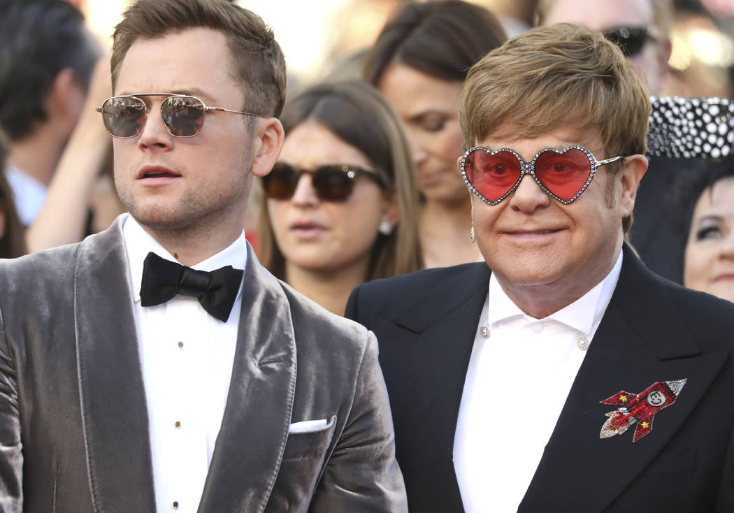 Actor Taron Egerton, left, and singer Elton John pose for photographers upon arrival at the pre ...