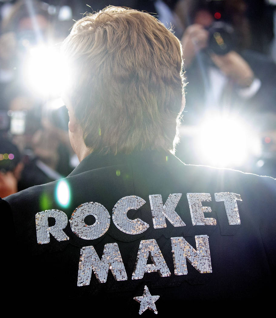Musician Elton John poses for photographers upon his arrival at the premiere of the film 'Rocke ...