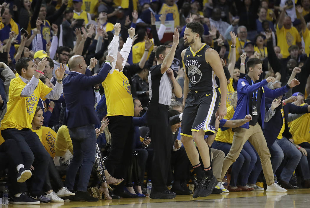 Golden State Warriors guard Klay Thompson (11) celebrates with fans after scoring against the P ...