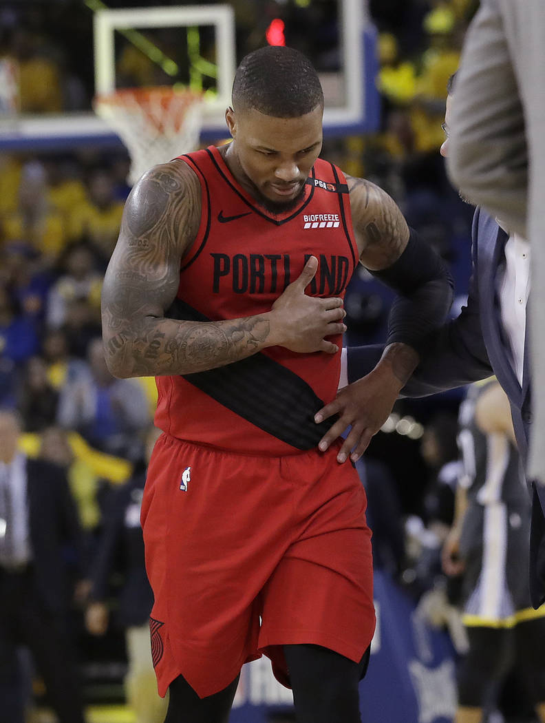 Portland Trail Blazers guard Damian Lillard walks to the bench during the second half of Game 2 ...