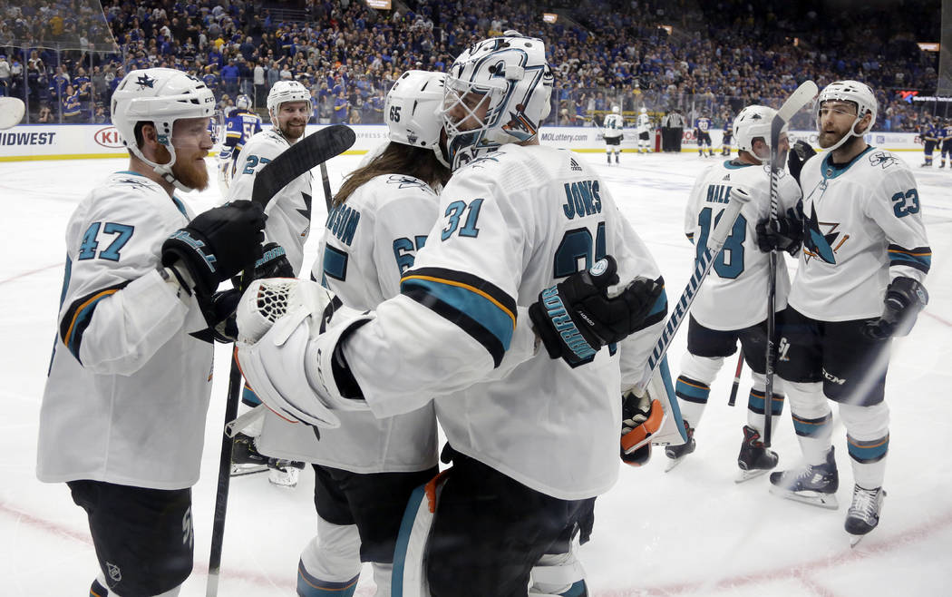 San Jose Sharks goaltender Martin Jones (31) celebrates with Joakim Ryan (47) and Erik Karlsson ...