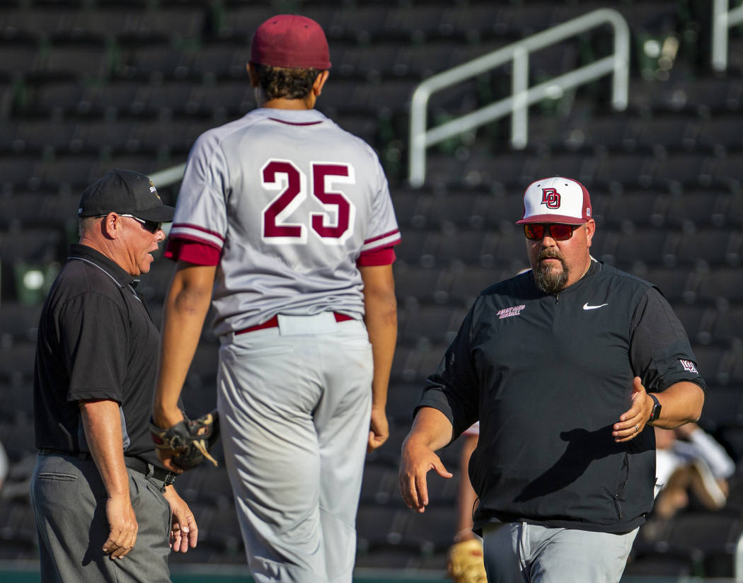 (From right) Desert Oasis head coach Paul Buboltz argues a balk call on his pitcher Aaron Rober ...
