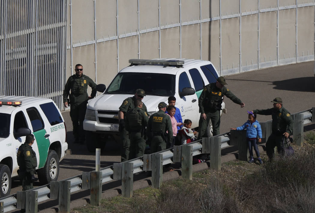 FILE - In this Dec. 9, 2018 file photo, a woman and children are ushered into cars by U.S. Bord ...