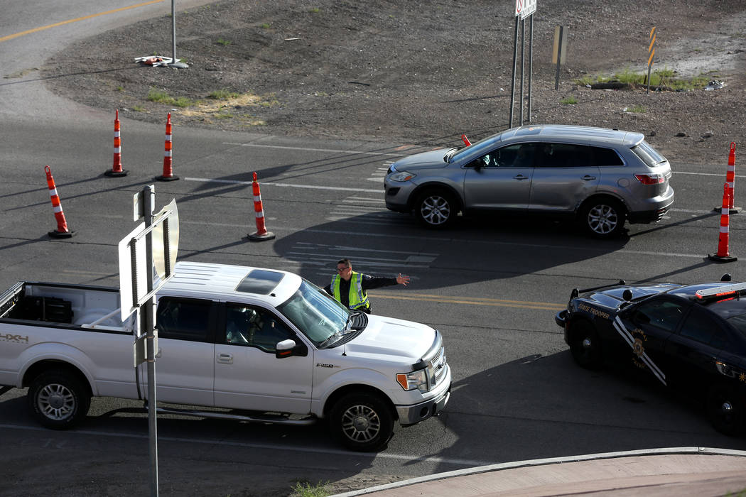 A Nevada Highway Patrol trooper manages traffic as attendees of the Electric Daisy Carnival exi ...