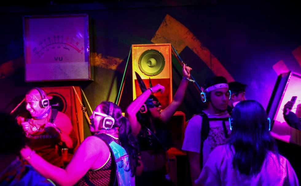 Attendees dance at a silent disco dance room during the first day of the Electric Daisy Carniva ...
