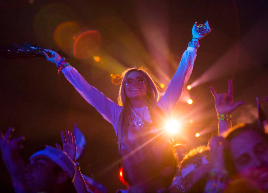 Attendees dance as Alesso performs at the Kinetic Field stage during the first day of the Elect ...