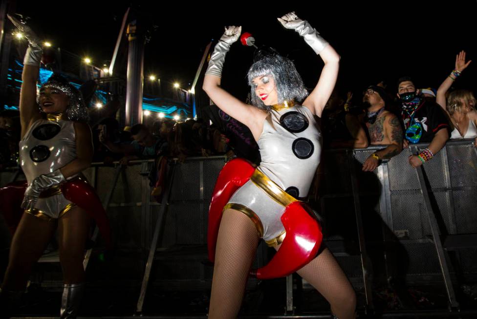 Costumed performers entertain attendees as Excision performs at the Kinetic Field stage during ...