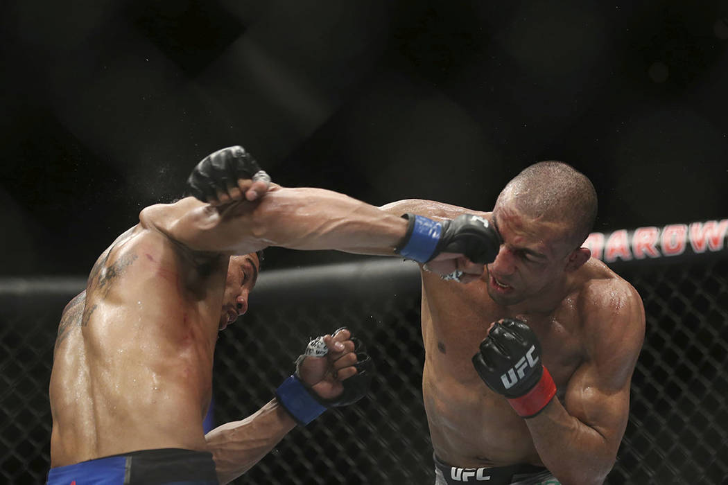 Kevin Lee, left, hits Edson Barboza during the fourth round of their mixed martial arts lightwe ...