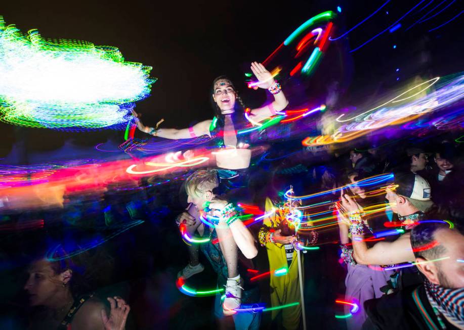 Attendees dance as Skrillex, not pictured, performs at the Circuit Grounds stage during the sec ...