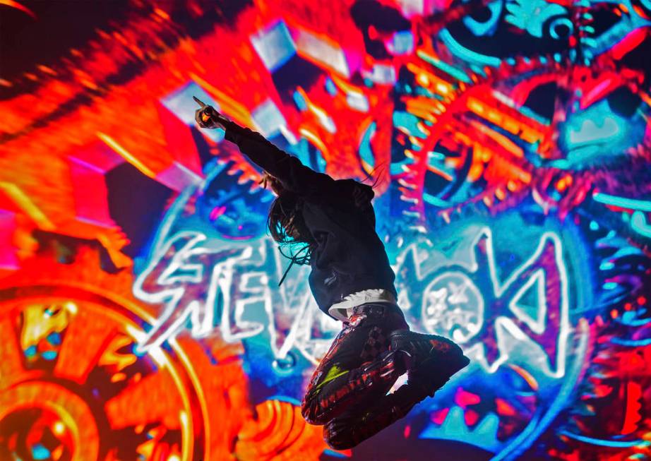 Steve Aoki leaps in the air during his performance at the Circuit Grounds stage on day three of ...