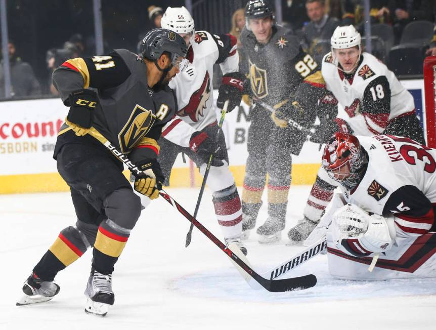 Arizona Coyotes goaltender Darcy Kuemper (35) blocks a shot in front of Golden Knights center P ...