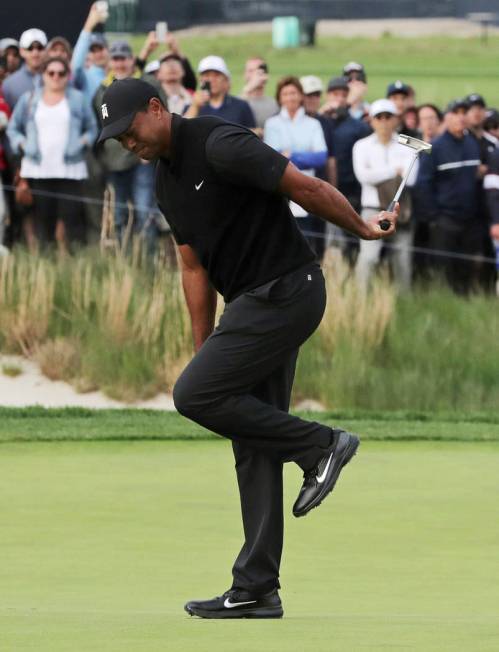 Tiger Woods reacts after missing a putt for birdie on the 17th green during the second round of ...