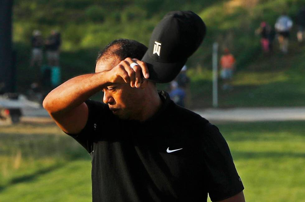 Tiger Woods removes his hat after finishing the second round of the PGA Championship golf tourn ...