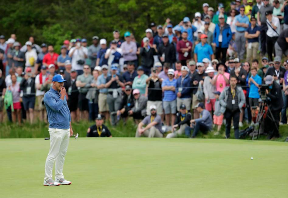 Brooks Koepka reacts after missing a putt for birdie on the eighth green during the second roun ...