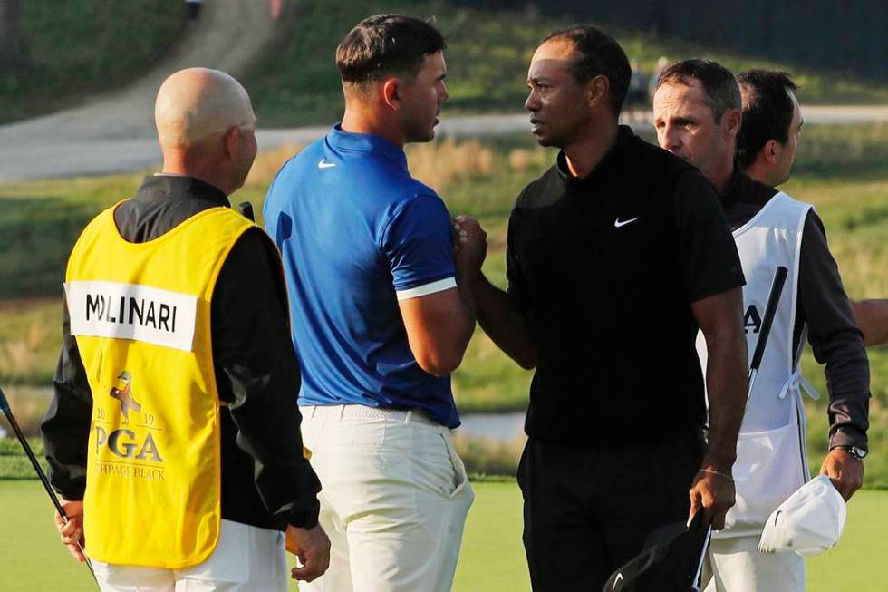 Brooks Koepka and Tiger Woods shake hands after finishing the second round of the PGA Champions ...