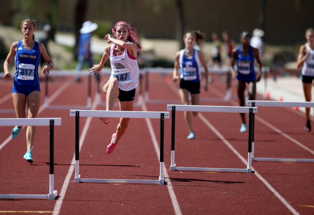 Quincy Bonds of Centennial, second from left, on her way to winning Class 4A 300 meter hurdles ...