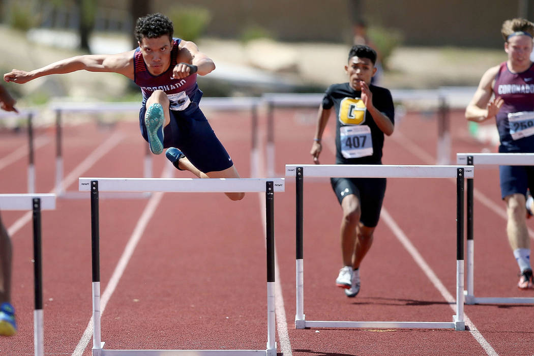 Justin Watterson of Coronado, left, on his way to winning Class 4A 300 meter hurdles in the sta ...