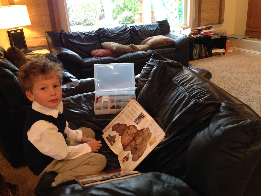 Jack Stark at 5 studying an atlas his mom gave him. (Courtesy)