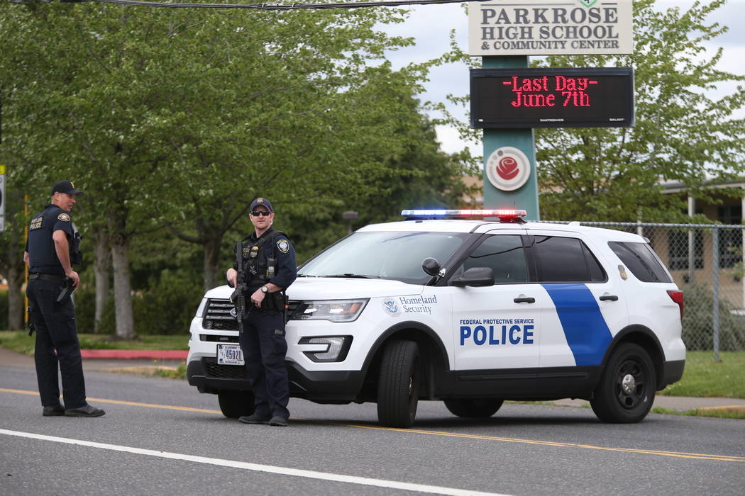 Police are positioned outside Parkrose High School Parkrose High School during a lockdown after ...