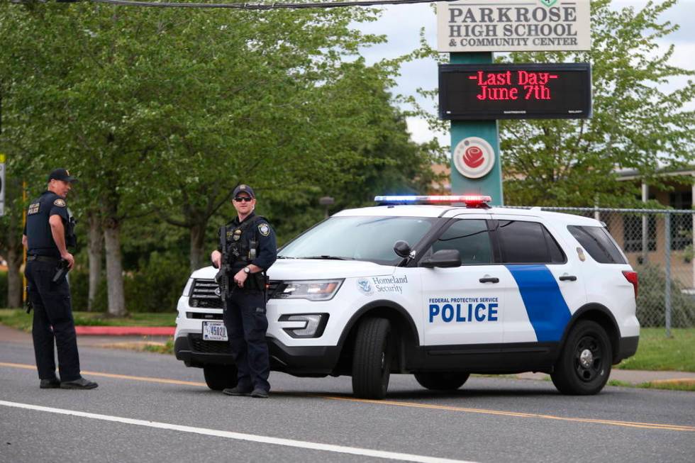 Police are positioned outside Parkrose High School Parkrose High School during a lockdown after ...