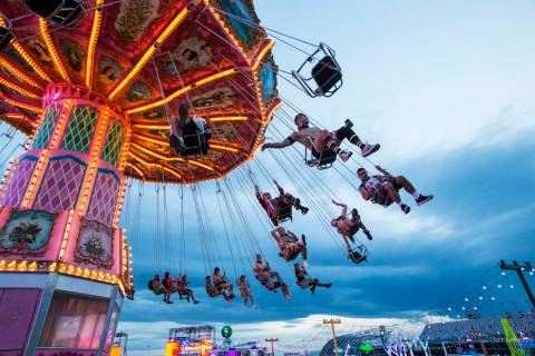 Attendees enjoy a carnival ride during the second day of the Electric Daisy Carnival at the Las ...