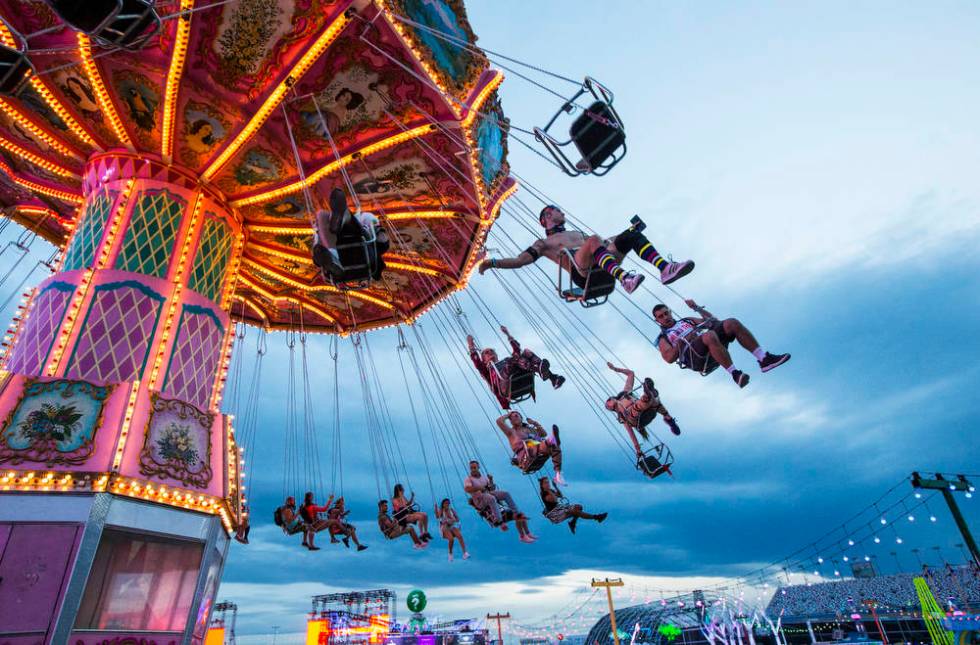 Attendees enjoy a carnival ride during the second day of the Electric Daisy Carnival at the Las ...