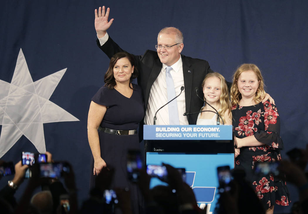 Australian Prime Minister Scott Morrison, second left, arrives on stage to speak to party suppo ...