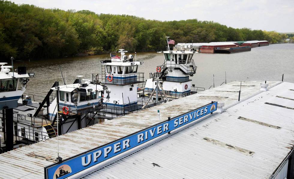 In this Tuesday, May 14, 2019 photo, empty barges, background right, are moored at the Upper Ri ...