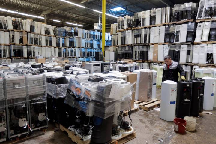 In this May 7, 2019 photo, water coolers are stacked and ready to be broken down into parts for ...