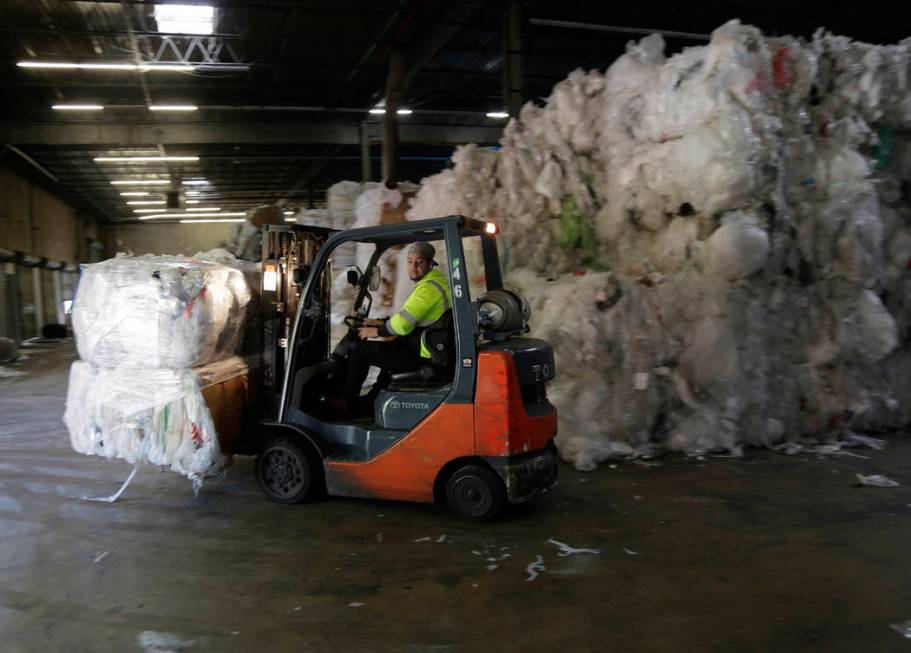 In this May 7, 2019 photo, a forklift moves through stacks of recyclables at a GDB Internationa ...