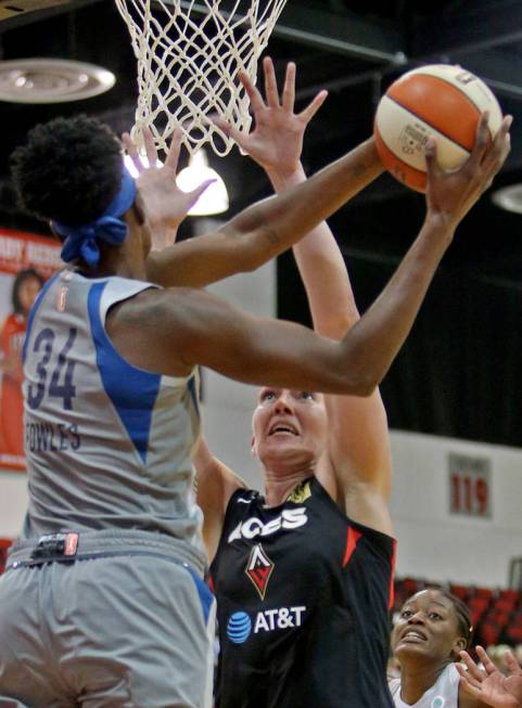 Minnesota Lynx Sylvia Fowles (34) tries a basket past Las Vegas Aces Carolyn Swords (8) at a pr ...