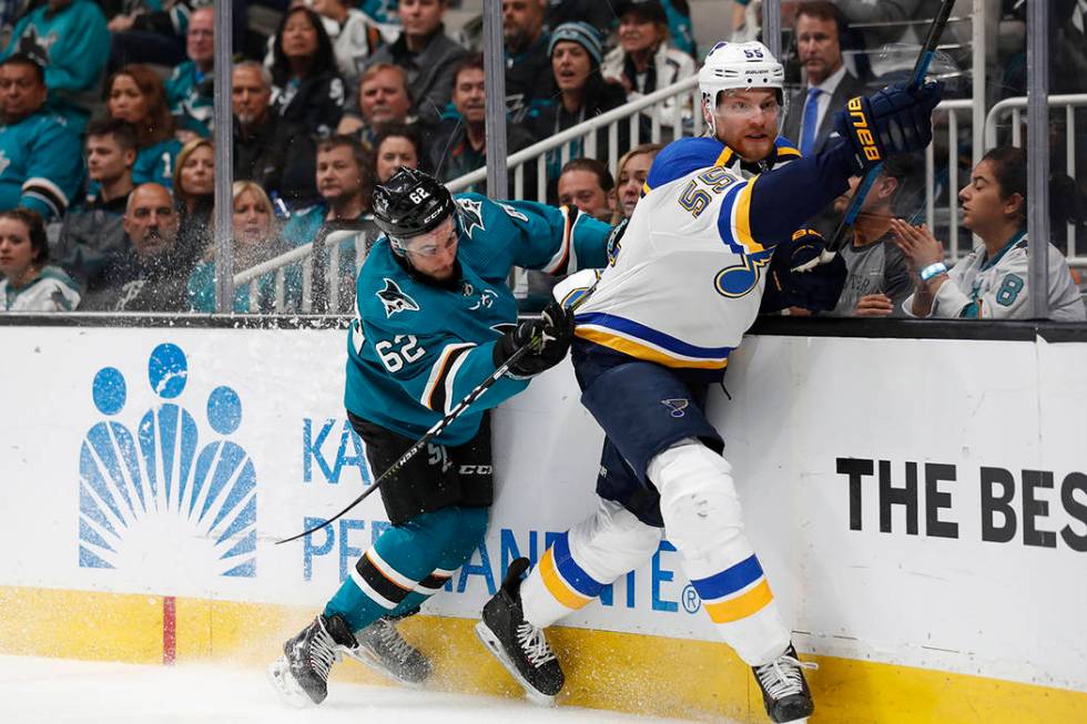 San Jose Sharks' Kevin Labanc (62) battles against the boards with St. Louis Blues' Colton Para ...