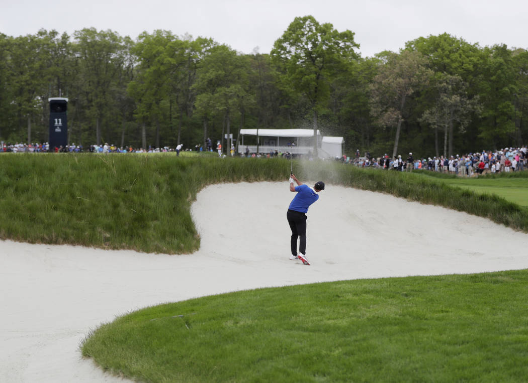 Brooks Koepka hits out of a bunker on the 11th hole during the final round of the PGA Champions ...