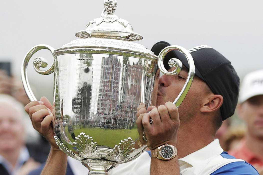 Brooks Koepka kisses the Wanamaker trophy after winning the PGA Championship golf tournament, S ...