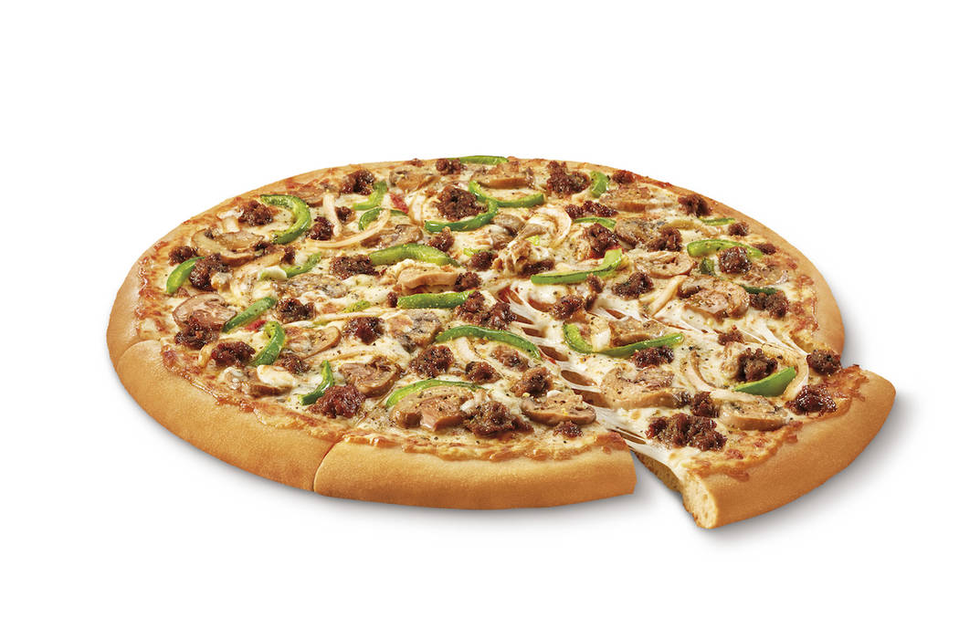 This undated image provided by Little Caesars shows the Impossible Supreme pizza. Plant-based b ...