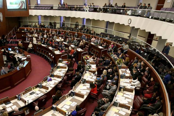 Lawmakers are seen in the Legislative Building in Carson City on the first day of the 80th sess ...