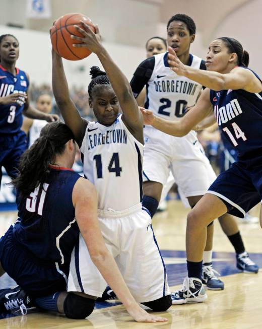 Georgetown guard Sugar Rodgers, 14, takes the ball away from Connecticut center Stefanie Dolson ...