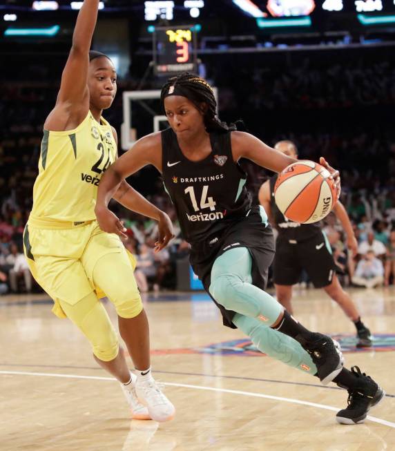 Seattle Storm's Jewell Loyd, left, defends against New York Liberty's Sugar Rodgers in the thir ...