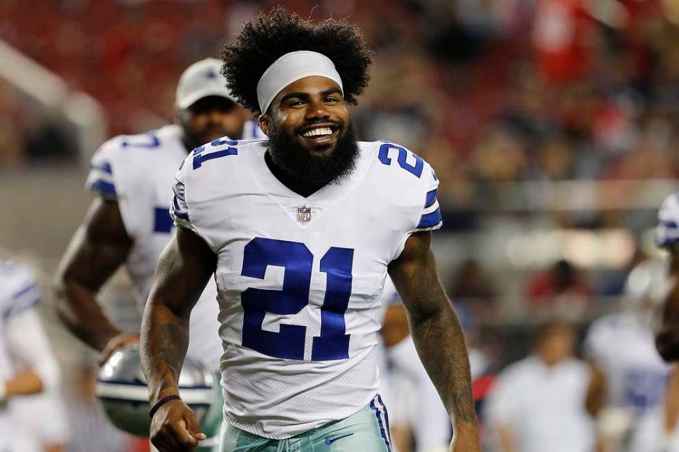 In this Aug. 9, 2018, file photo, Dallas Cowboys running back Ezekiel Elliott (21) smiles as he ...