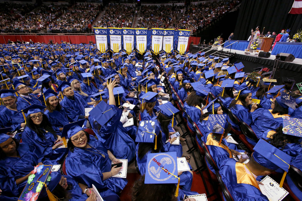 Graduates wave to their families during College of Southern Nevada commencement ceremony at Tho ...