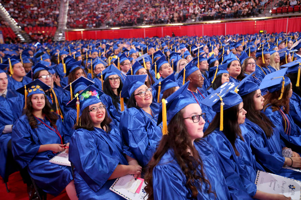 Graduates listen to speakers during College of Southern Nevada commencement ceremony at Thomas ...