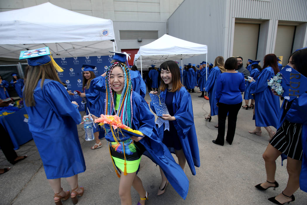 Graduates, including Yuriko Matsuo, left, prepare for the College of Southern Nevada commenceme ...