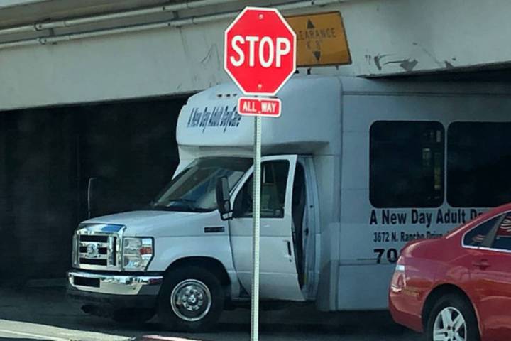 A shuttle van is stuck underneath the U.S. Highway 95 underpass at Las Vegas Blvd. South on Mon ...