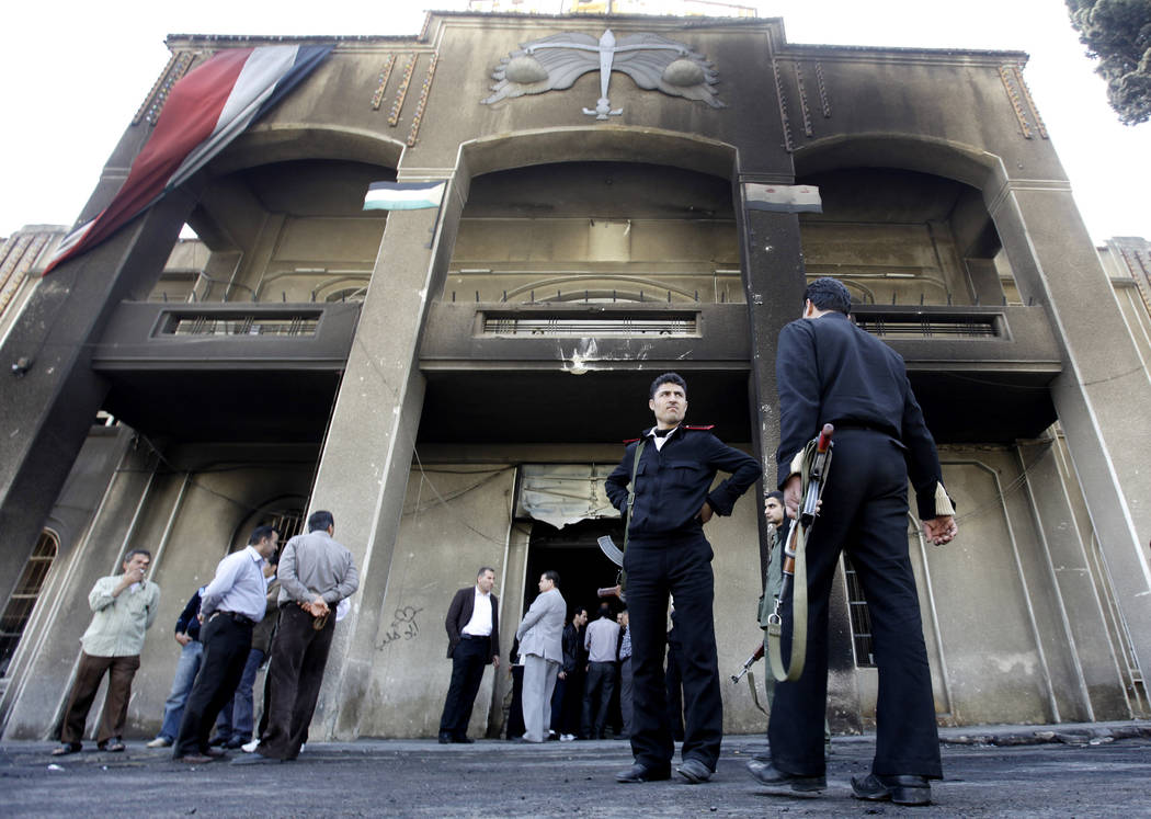 FILE - In this March 21, 2011 file photo, Syrian policemen stand in front of a court building t ...