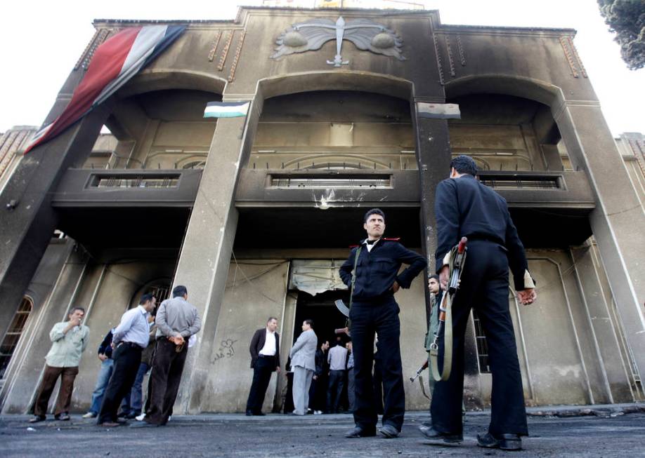 FILE - In this March 21, 2011 file photo, Syrian policemen stand in front of a court building t ...
